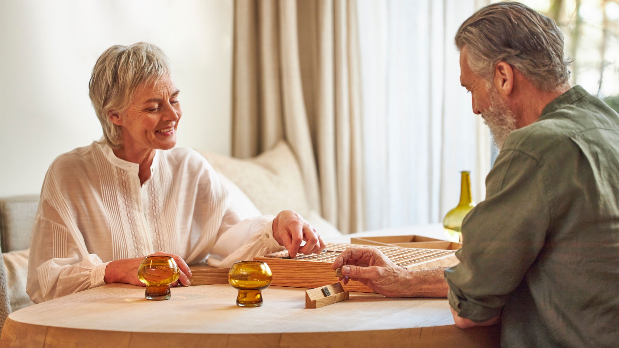 Couple playing board games while enjoying a perfect room temperature